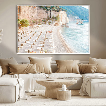 Wall art of a calm Mediterranean beach with rows of sun loungers and umbrellas in soft pastel tones, perfect for light coastal or vacation-themed decor.