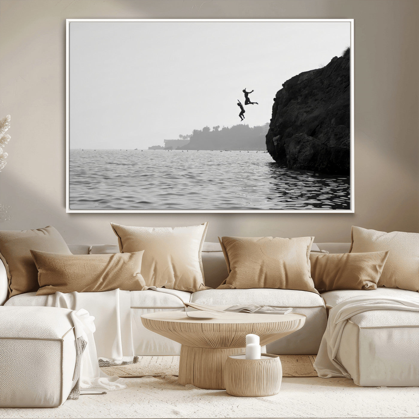 Black and white canvas of two figures cliff jumping into the sea, captured with moody tones, ideal for modern coastal or adventure-themed home decor.   2/2