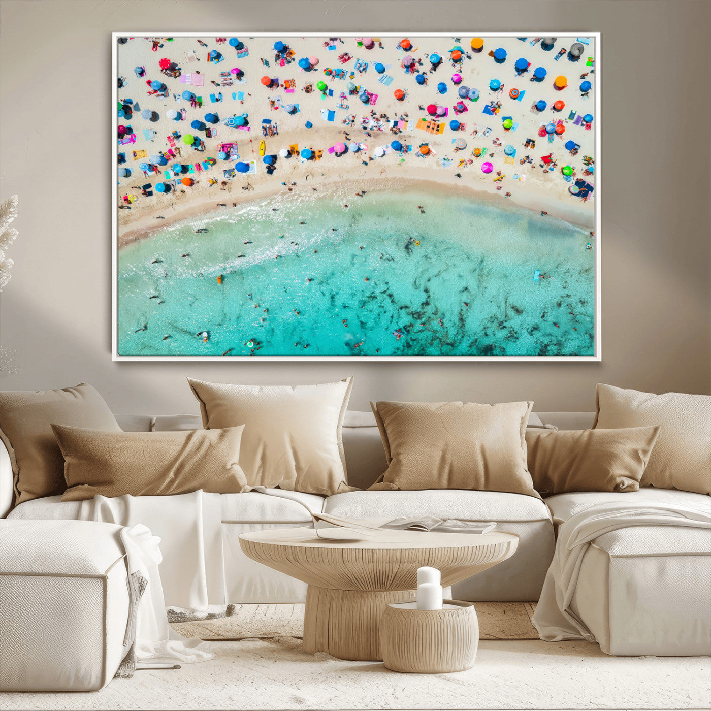 Aerial view of a vibrant beach filled with colorful umbrellas and people enjoying the turquoise ocean, capturing a lively summer vacation scene.