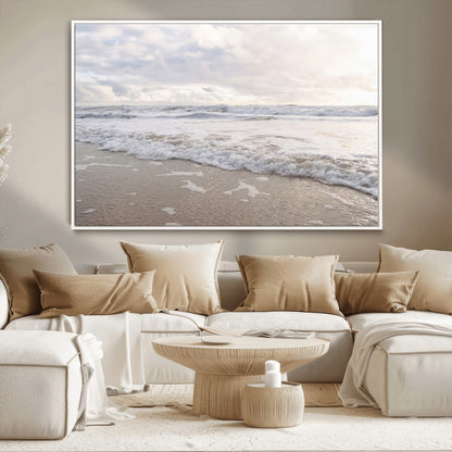 Peaceful ocean waves rolling onto the sandy shore under soft light, perfect for neutral or coastal minimalist decor themes.