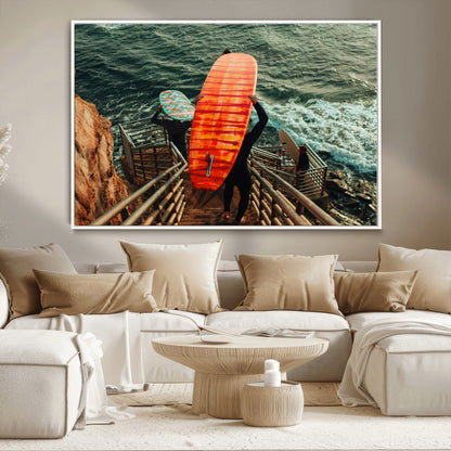 A surfer carrying a bold orange surfboard down a rugged staircase toward the ocean, bathed in golden hour light, capturing the energy of coastal adventure.