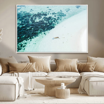 Canvas featuring an aerial view of a swimmer in shallow turquoise waters with coral patterns, ideal for tropical coastal home decor.