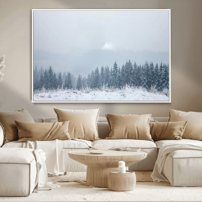 Snow-covered forest under misty sky, soft light breaking through clouds, ideal for minimalist or Nordic-inspired home decor.