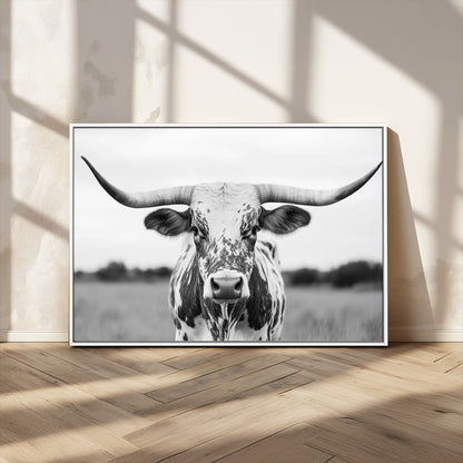 Capture the strength and elegance of nature with this striking black and white portrait of a longhorn cow. Its powerful presence makes a bold statement in any room.