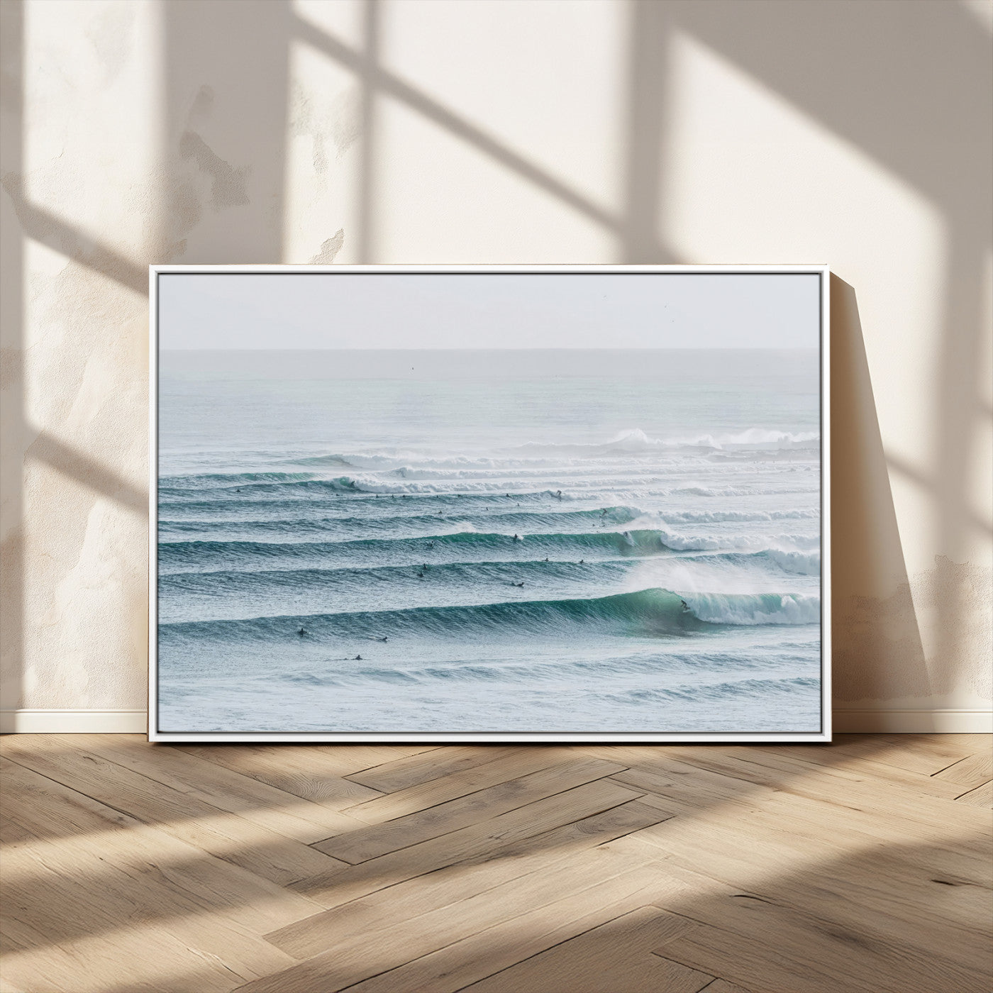 High-angle view of surfers lining up across layered ocean waves, ideal for minimal coastal or surf-inspired room decor.