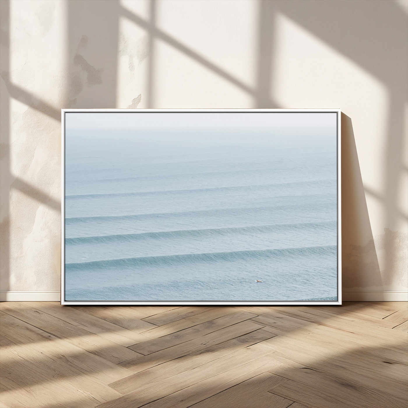 Framed canvas of repeating ocean waves with a distant solo surfer, ideal for minimalist ocean or calm coastal wall decor.