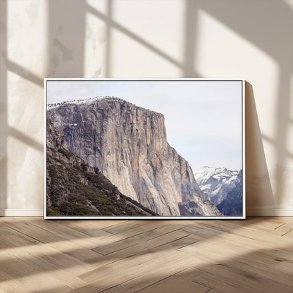 Framed canvas of El Capitan’s vertical granite face in Yosemite with snowy peaks, ideal for Sierra minimalism or mountain-inspired decor.