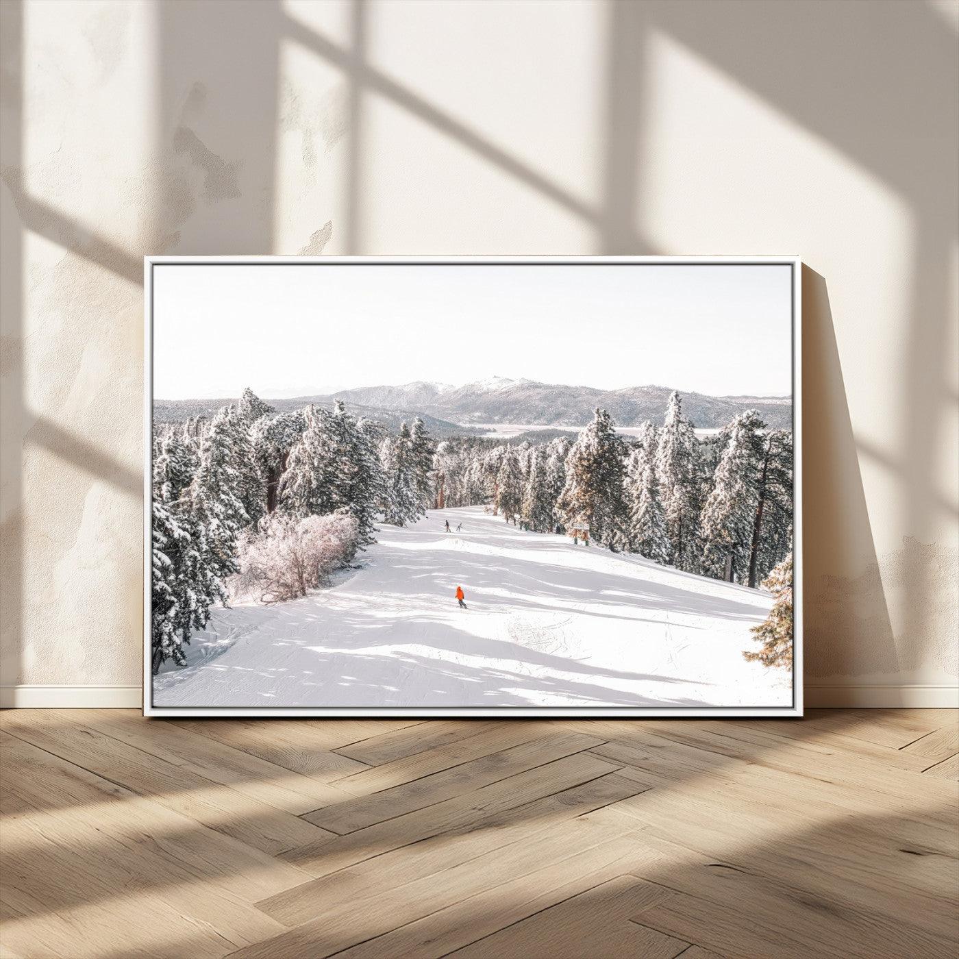 Bright ski trail lined with snow-covered pines and a skier in orange, perfect for alpine adventure or winter sports-inspired decor.