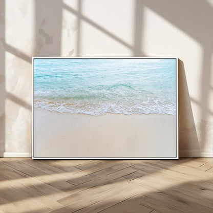 Soft shoreline with gentle aqua waves on smooth sand, ideal for minimalist coastal or pastel ocean-inspired home wall decor.