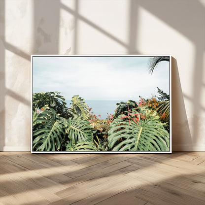 Monstera leaves and tropical flowers framing a calm ocean view, ideal for tropical coastal or exotic jungle-style interior wall decor.
