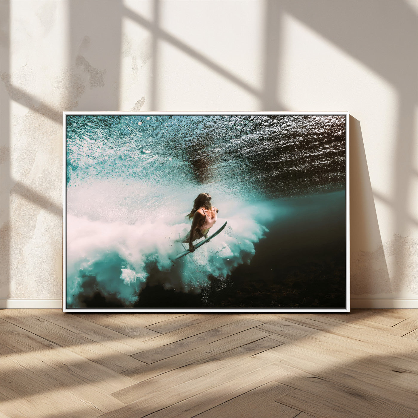 Vibrant underwater photo of a female surfer diving through turquoise waves, perfect for coastal boho or surf-inspired home decor.