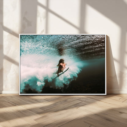 Vibrant underwater photo of a female surfer diving through turquoise waves, perfect for coastal boho or surf-inspired home decor.