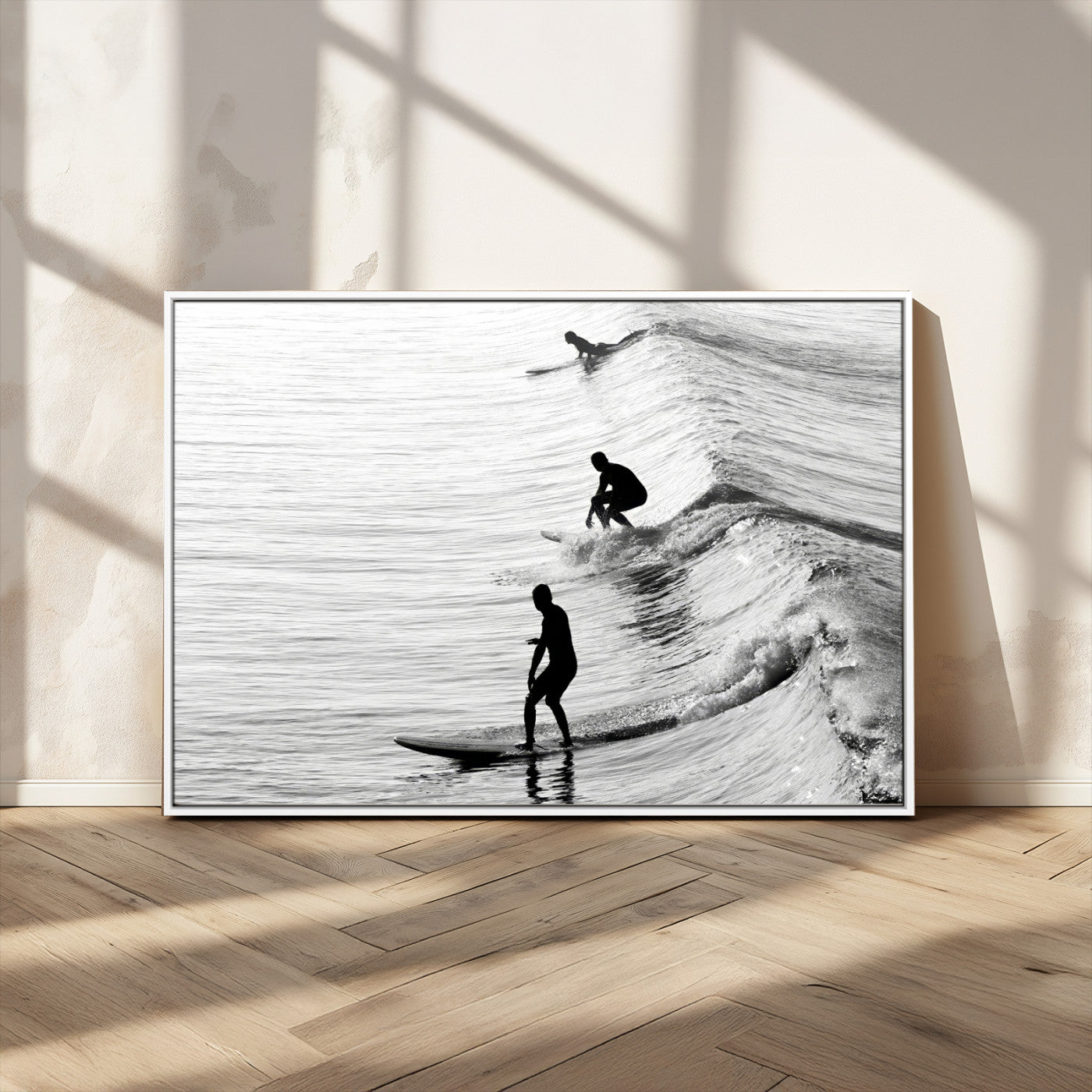 Black and white photo of surfers riding waves in a moody, high-contrast scene, ideal for modern coastal or surf-inspired home decor.