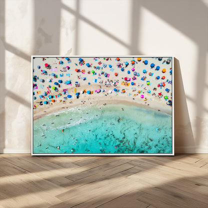 Aerial view of a vibrant beach filled with colorful umbrellas and people enjoying the turquoise ocean, capturing a lively summer vacation scene.