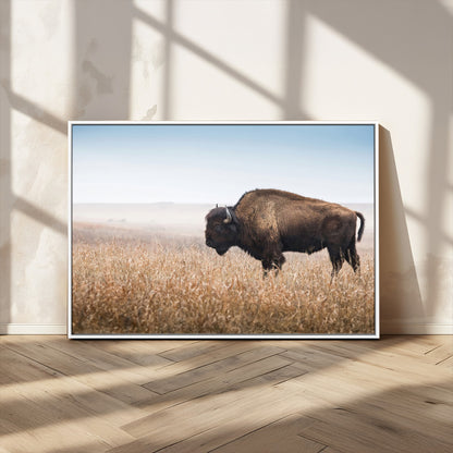 A majestic bison standing in an open prairie field, its strong form blending into the golden grass under a vast blue sky, evoking the wild spirit of the American plains.