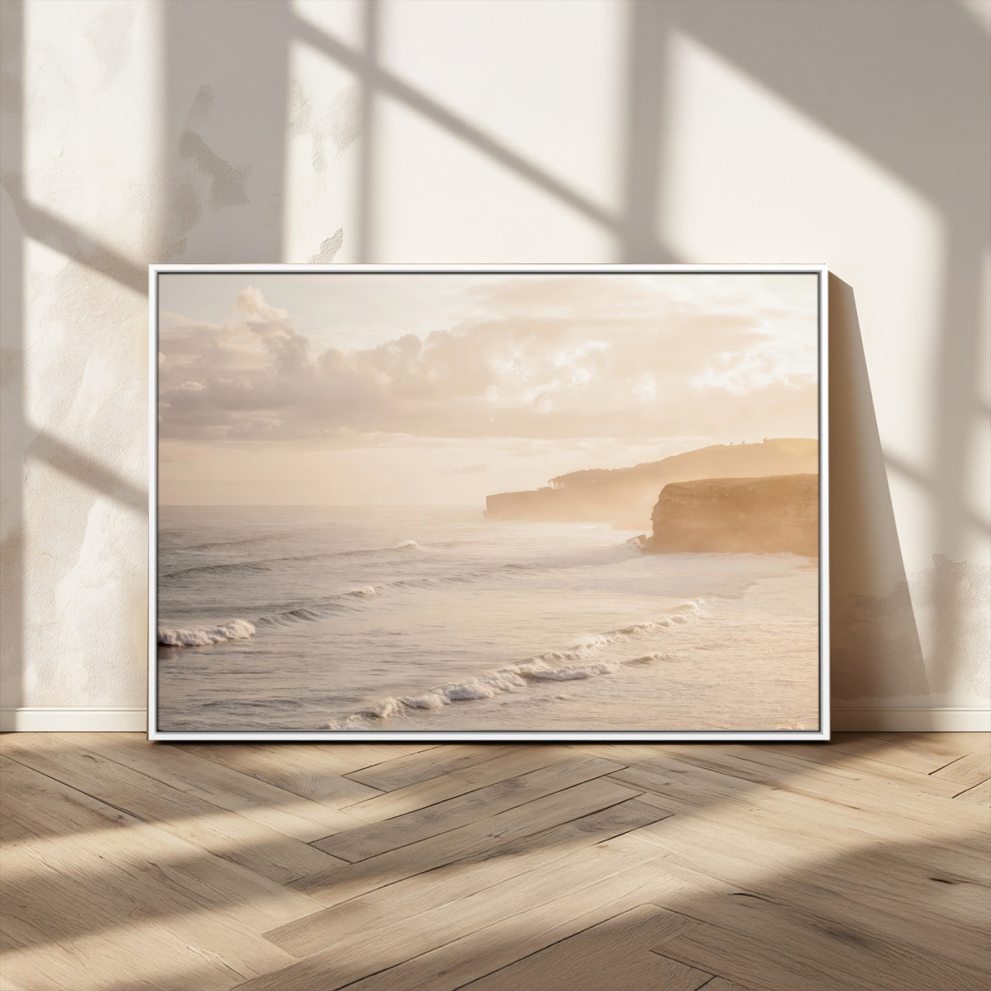 Golden hour seascape with misty cliffs and gentle waves rolling towards the shore, capturing a tranquil and warm coastal atmosphere.