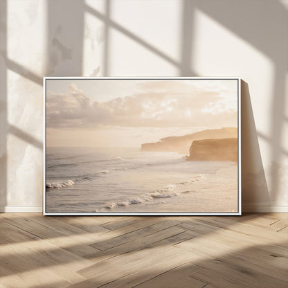 Golden hour seascape with misty cliffs and gentle waves rolling towards the shore, capturing a tranquil and warm coastal atmosphere.