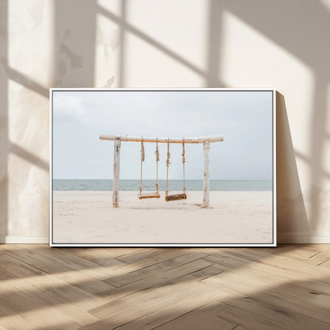 A rustic wooden beach swing stands on a serene sandy shore with an ocean horizon in the background, creating a tranquil and dreamy coastal escape.