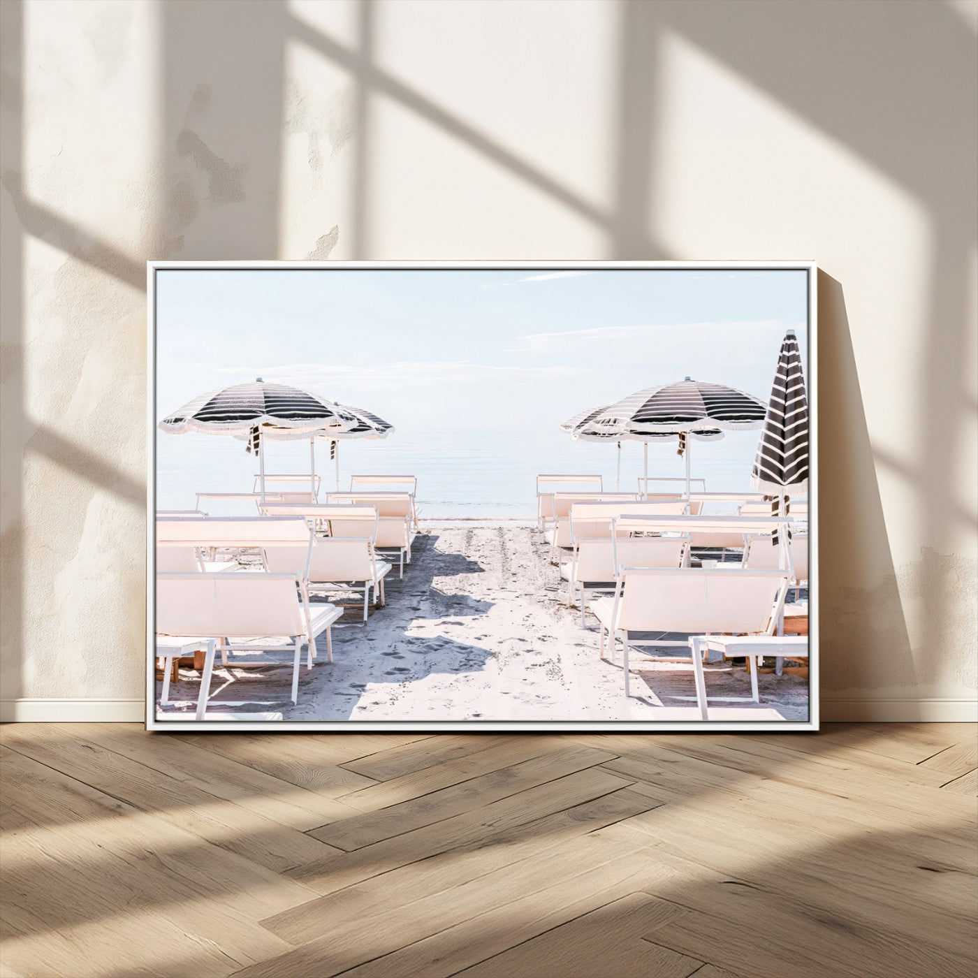 A serene minimalist beach scene featuring striped umbrellas, soft pastel sand, and an elegant lounge setup, creating a tranquil and stylish coastal retreat.