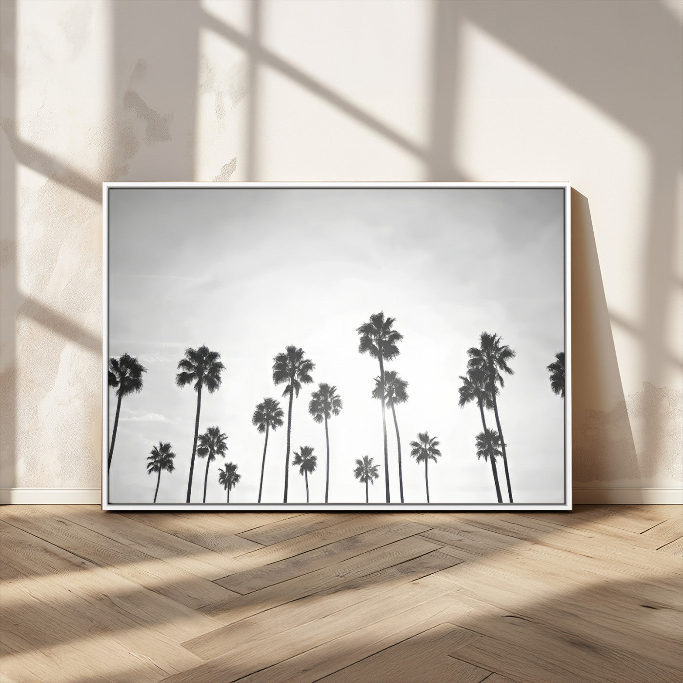 A black and white minimalist scene featuring tall palm trees silhouetted against a bright sky, creating a dreamy and timeless tropical aesthetic.