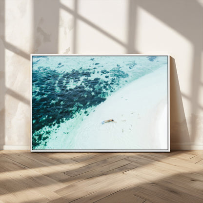 Canvas featuring an aerial view of a swimmer in shallow turquoise waters with coral patterns, ideal for tropical coastal home decor.