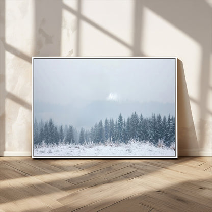 Snow-covered forest under misty sky, soft light breaking through clouds, ideal for minimalist or Nordic-inspired home decor.