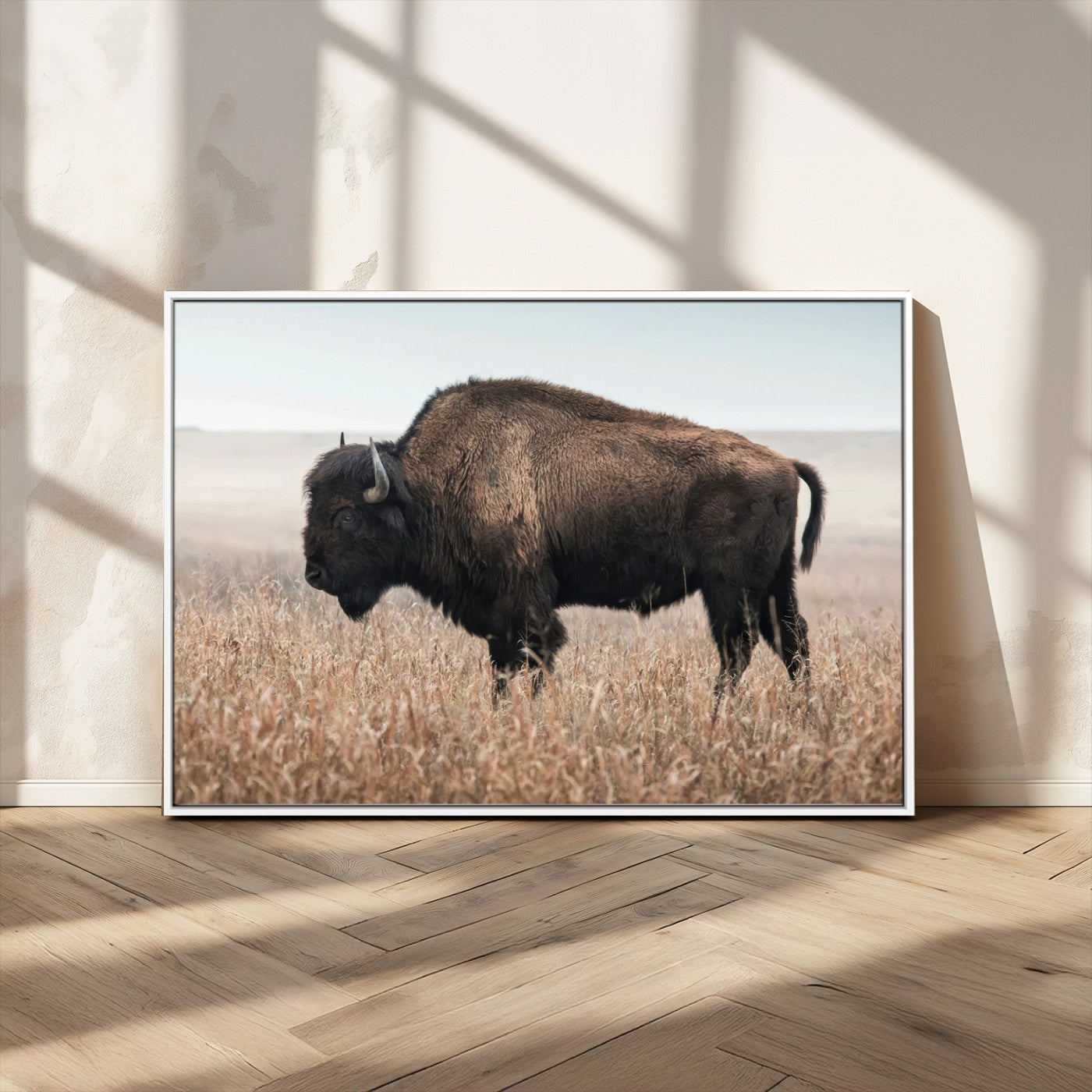 A lone bison stands in a vast prairie under a soft sky, evoking freedom and rustic charm for western or farmhouse inspired interiors.