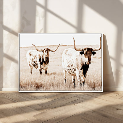 Two Texas longhorn cows standing in a sepia-toned pasture, evoking rustic charm perfect for farmhouse or western country interiors. (