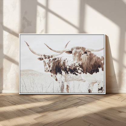Two longhorn cows standing in a sepia-toned pasture with soft light, ideal for rustic or farmhouse-themed neutral wall decor.