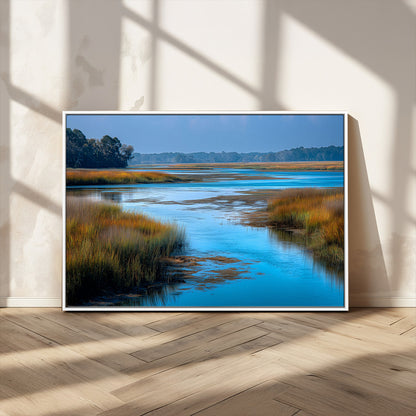 A peaceful marshland scene with calm blue water reflecting the surrounding grasses and trees, capturing the beauty of nature in a serene landscape.
