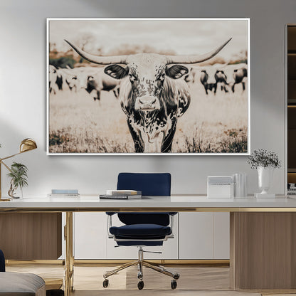 Canvas of a speckled Texas longhorn standing boldly in a field with a herd behind, perfect for rustic western or farmhouse wall decor.