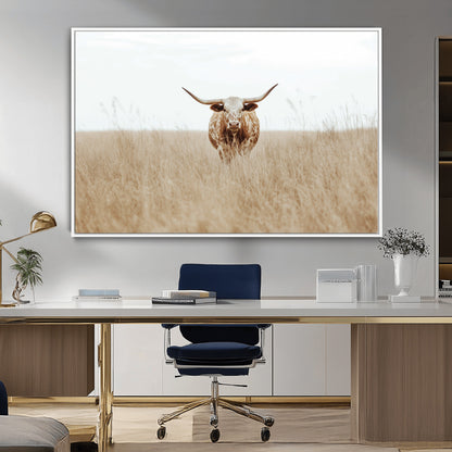 Texas Longhorn bull standing alone in dry grass with neutral tones, ideal for rustic western or cowboy-themed wall decor.