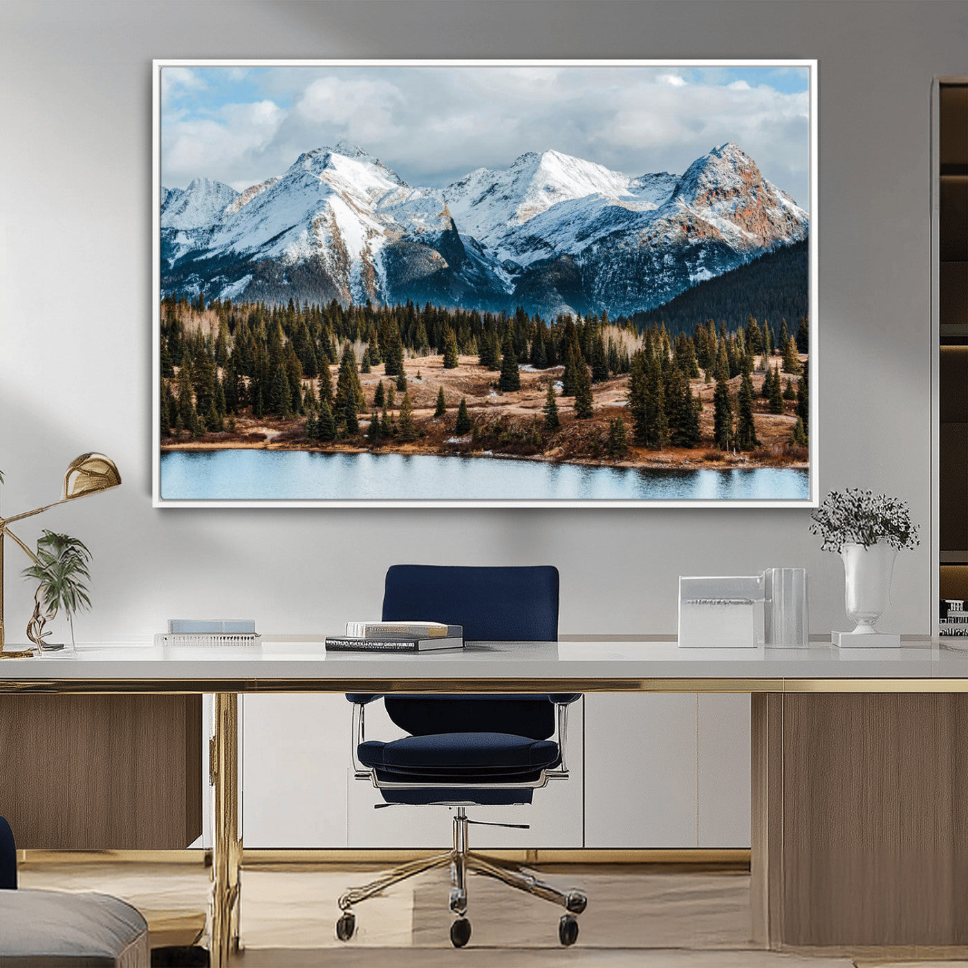 Framed canvas of snowy mountain peaks with pine forest and alpine lake, perfect for winter cabin or wilderness-inspired home decor.