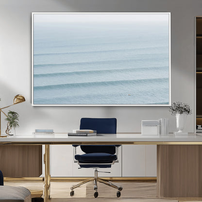 Framed canvas of repeating ocean waves with a distant solo surfer, ideal for minimalist ocean or calm coastal wall decor.