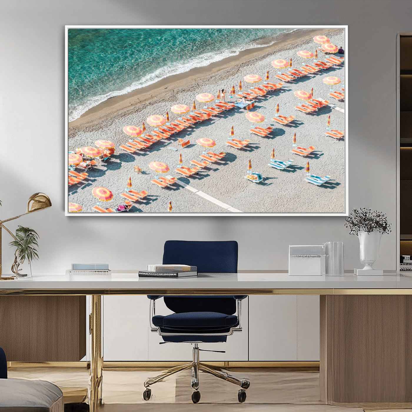 Framed canvas of colorful umbrellas and chairs on a Mediterranean beach, perfect for retro coastal or summer-themed home decor.