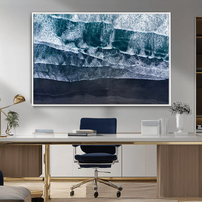 Canvas of aerial ocean waves crashing onto a black sand beach in moody tones, ideal for modern coastal or minimalist home decor.