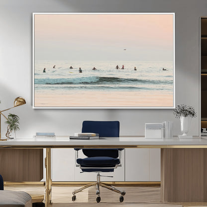 Dreamy photo of surfers waiting on soft pastel waves under a pink sunset sky, ideal for soft coastal minimalist or serene ocean-themed home decor.
