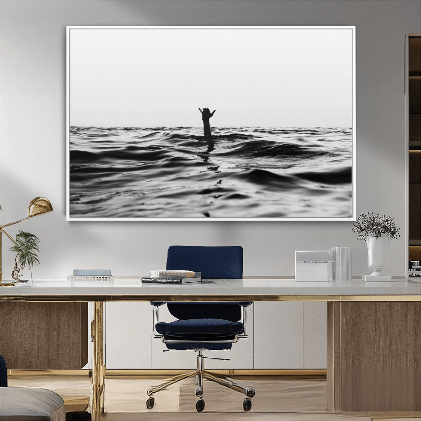 Black and white ocean with a hand making a surfer sign among dark waves, creating a dramatic and minimalist seascape with bold contrast.