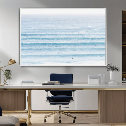 Minimalist ocean view with soft blue waves and a lone surfer, creating a serene and airy coastal aesthetic, perfect for tranquil home decor.