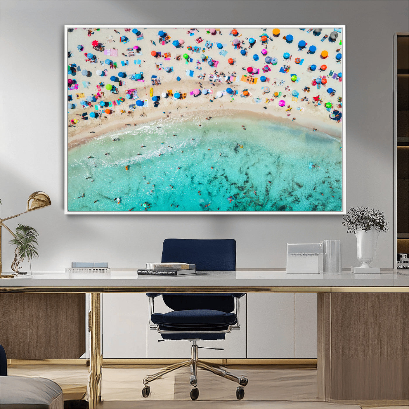 Aerial view of a vibrant beach filled with colorful umbrellas and people enjoying the turquoise ocean, capturing a lively summer vacation scene.