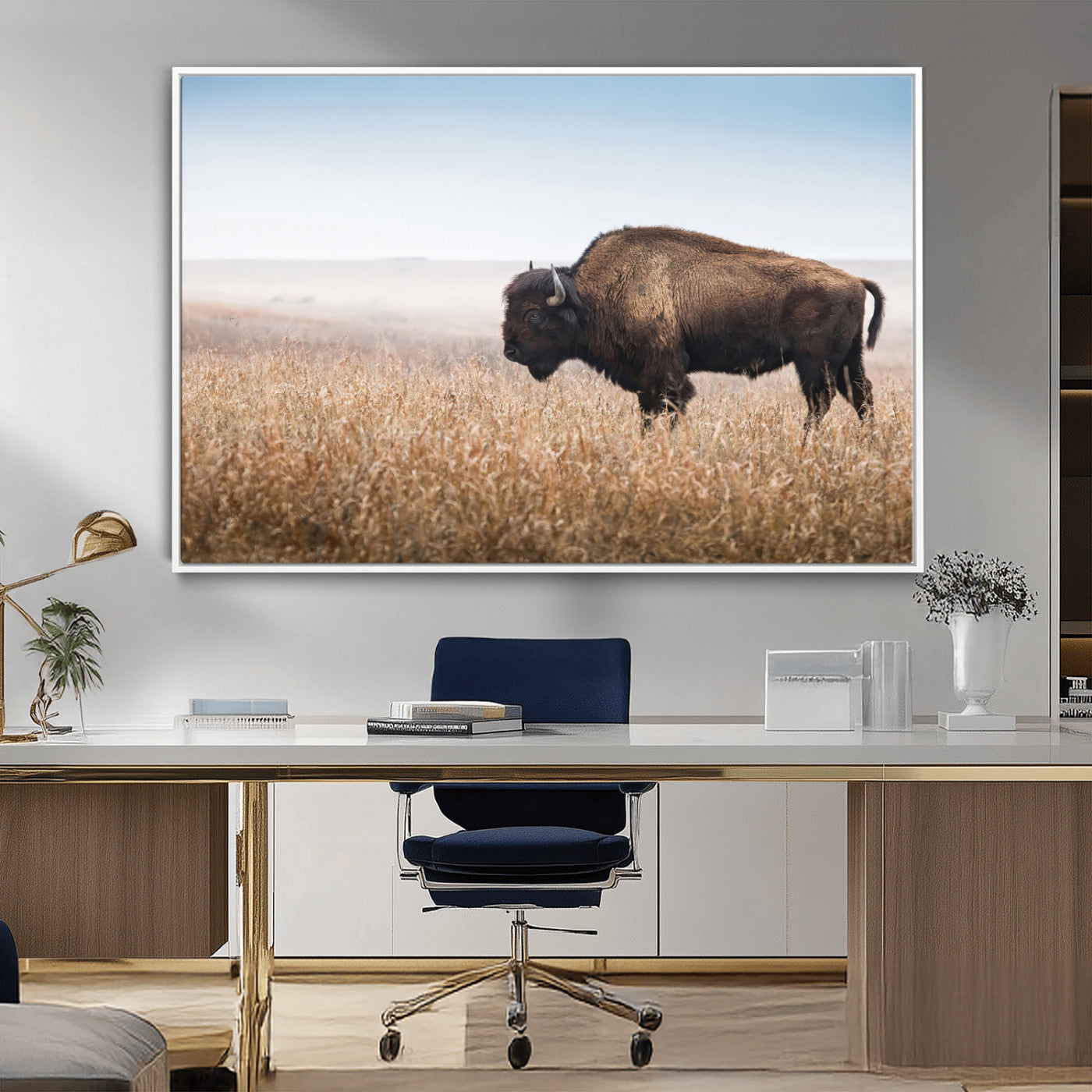 A majestic bison standing in an open prairie field, its strong form blending into the golden grass under a vast blue sky, evoking the wild spirit of the American plains.