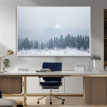 Snow-covered forest under misty sky, soft light breaking through clouds, ideal for minimalist or Nordic-inspired home decor.