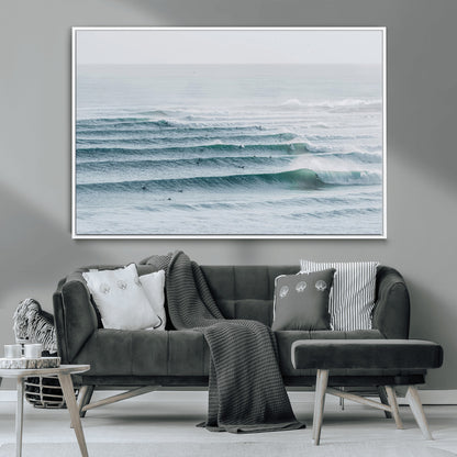 High-angle view of surfers lining up across layered ocean waves, ideal for minimal coastal or surf-inspired room decor.