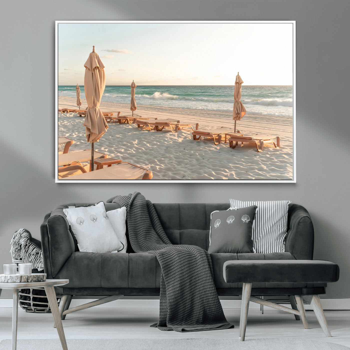 Minimalist photo of empty beach loungers and umbrellas on soft sand, ideal for calm seaside or pastel coastal-style home decor.