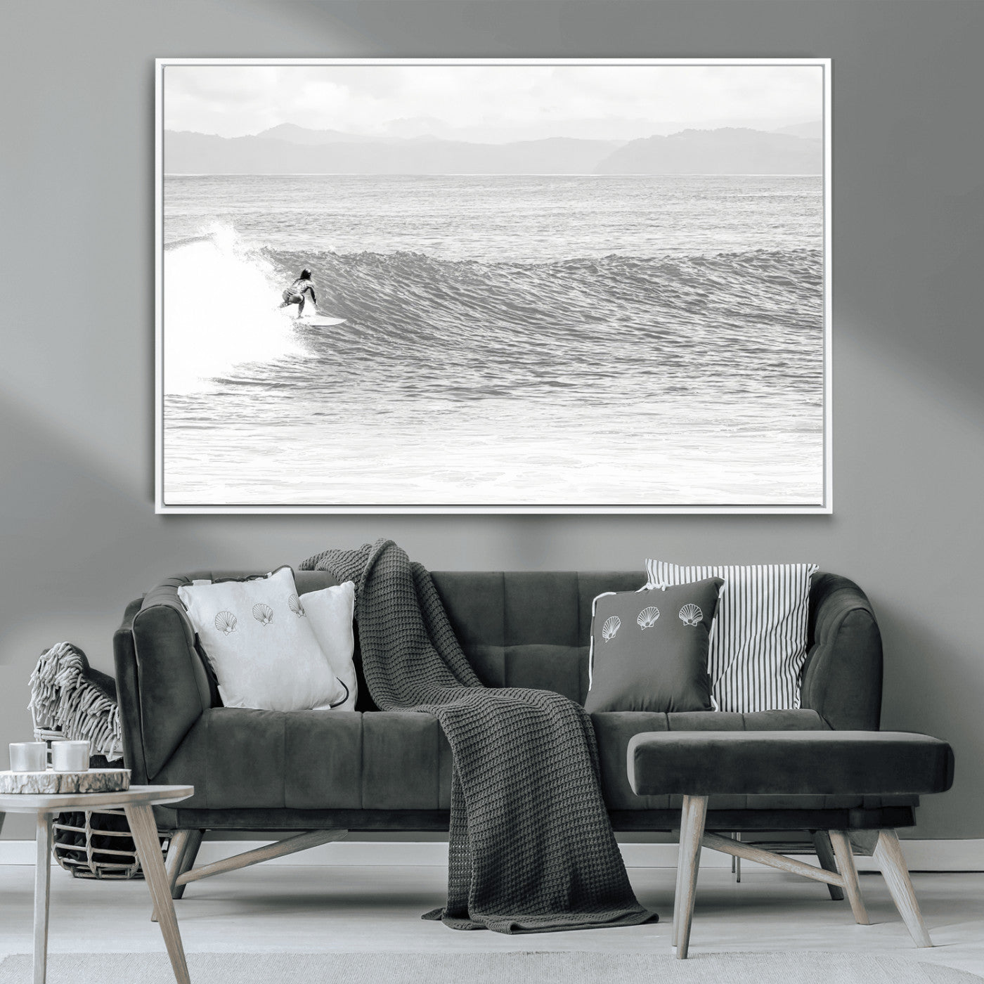 Monochrome photo of a surfer riding a wave with distant mountains, ideal for coastal motion or black and white surf-themed wall decor.