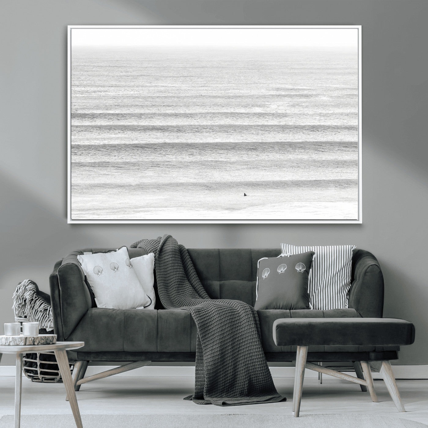 Monochrome photo of a lone surfer in calm layered waves, perfect for minimalist coastal or moody ocean-inspired wall decoration.