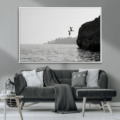 Black and white canvas of two figures cliff jumping into the sea, captured with moody tones, ideal for modern coastal or adventure-themed home decor.   2/2