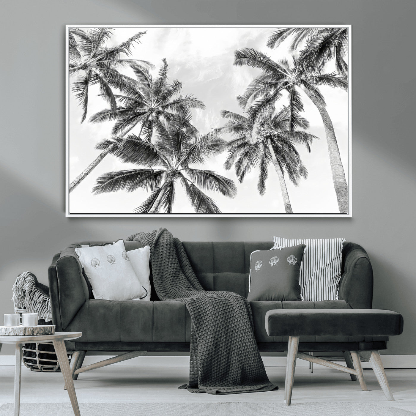 Black and white tropical palm trees viewed from below, swaying gently against a bright sky, creating a serene and elegant coastal atmosphere.