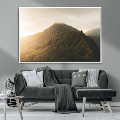 Sunlit mountain peak with mist rolling over its rugged slopes, bathed in golden light, creating a warm and tranquil nature-inspired scene.