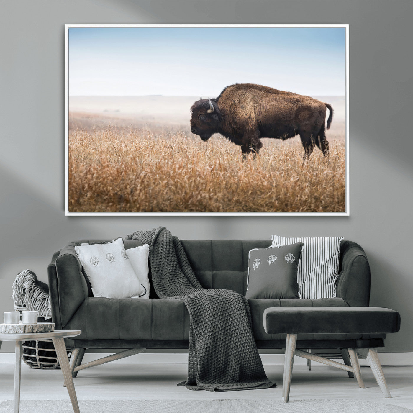 A majestic bison standing in an open prairie field, its strong form blending into the golden grass under a vast blue sky, evoking the wild spirit of the American plains.